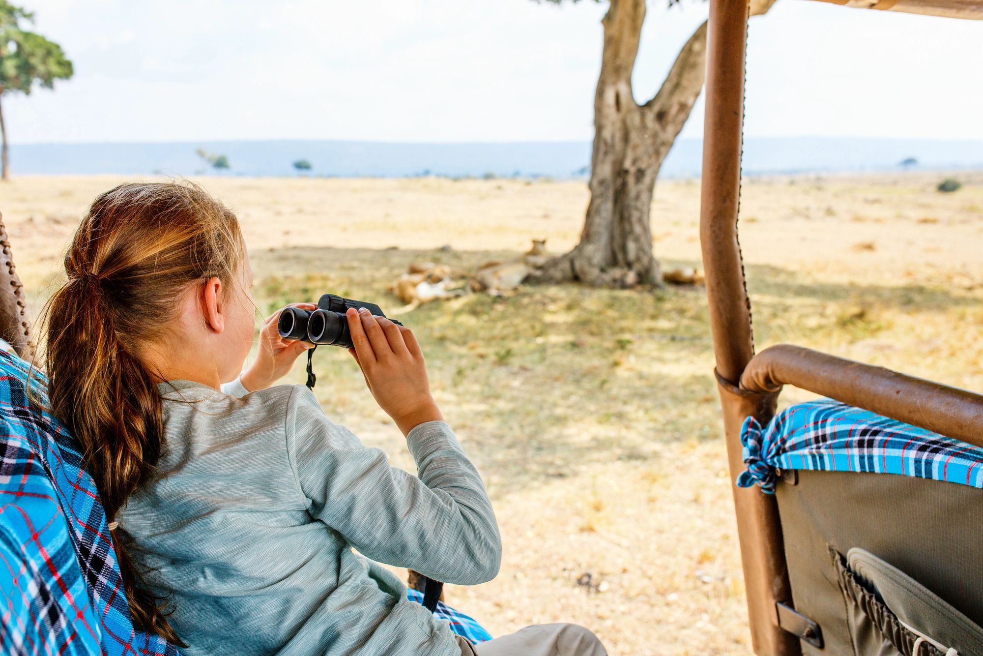 A girl using binoculars on a game drive